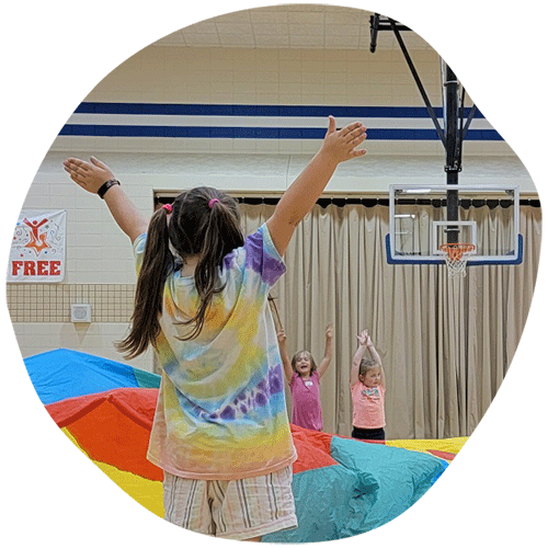 Little girl cheering with arms raised