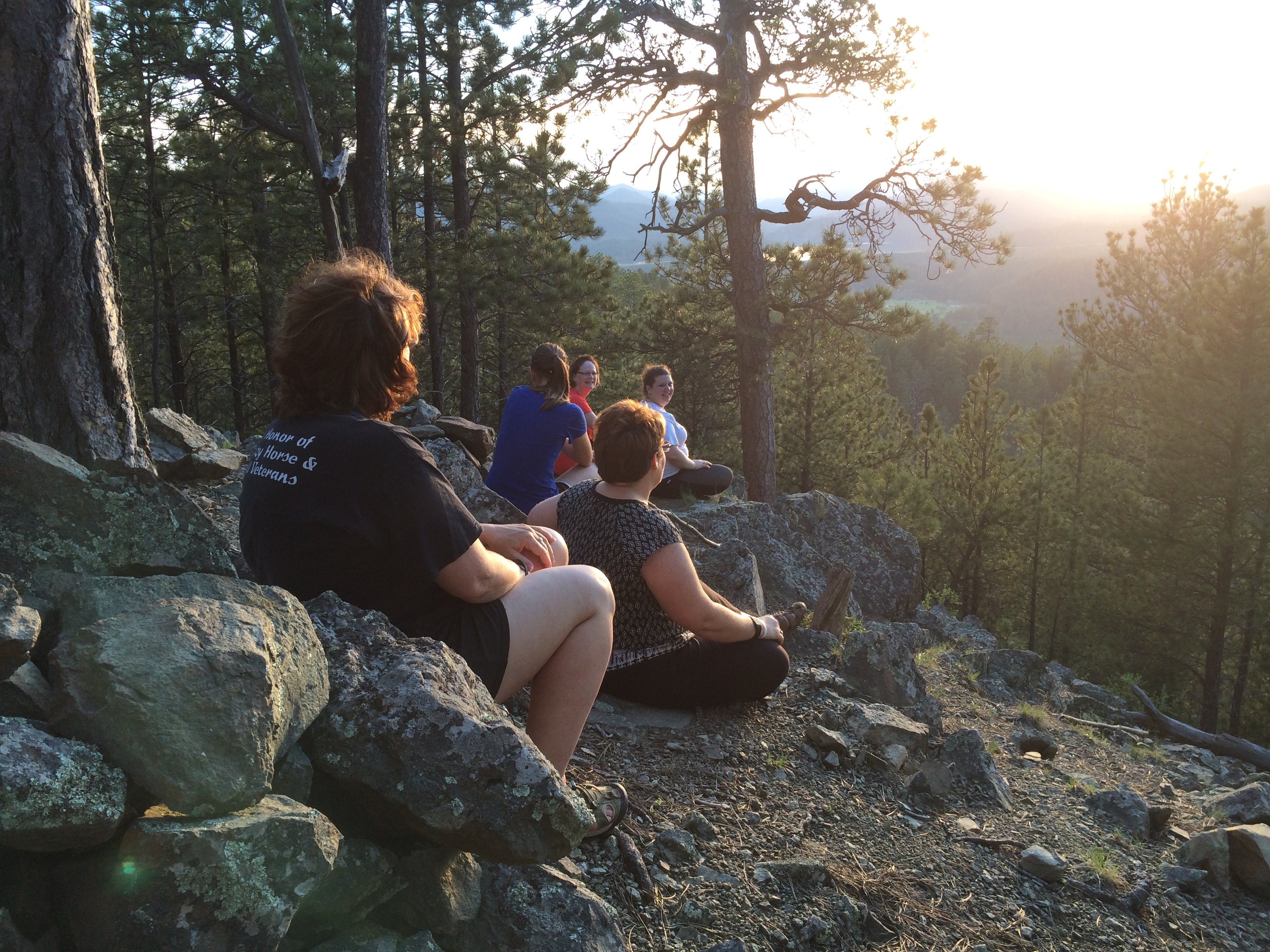 Group of people outdoors looking at sunset